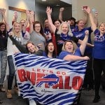 Northtowns Oral Surgery team photo - with Buffalo Bills banner and garb